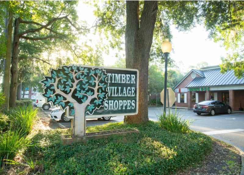 Sign for the Timber Village Shoppes shopping center